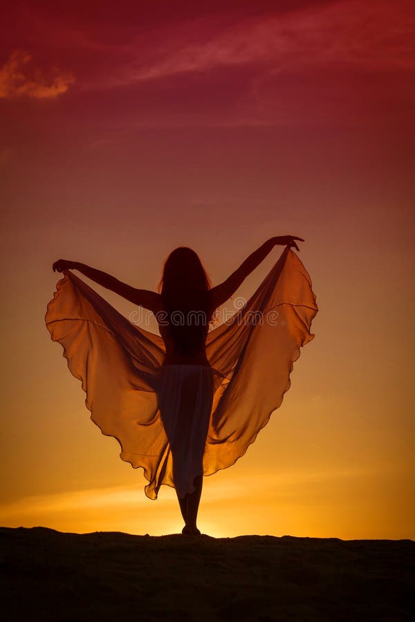 Beautiful woman posing on the beach at the sunset. Beautiful woman posing on the beach at the sunset