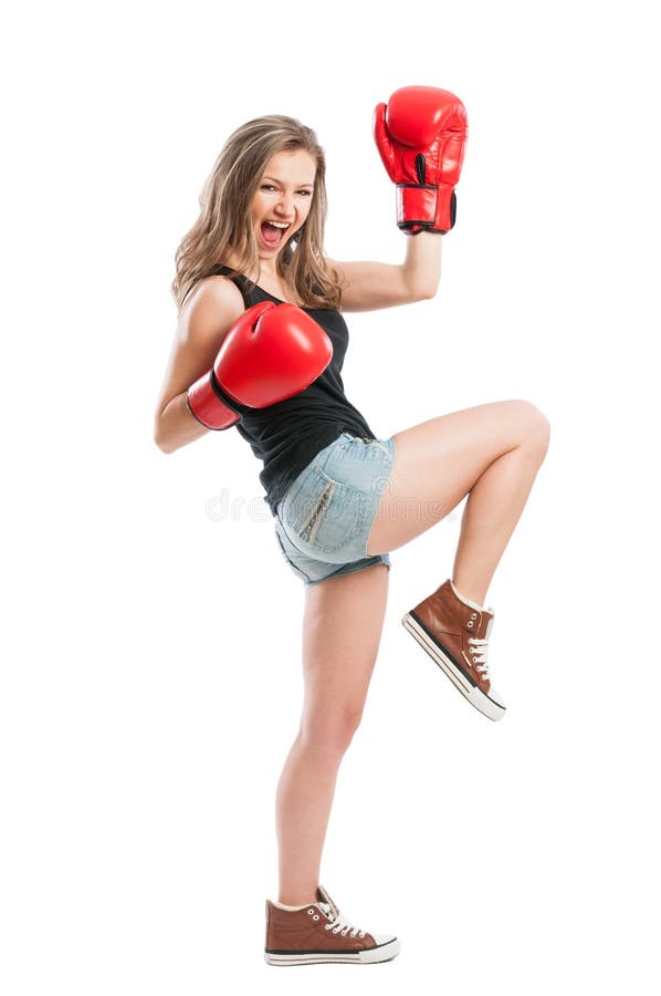 Beautiful female model with boxing gloves screaming and raising hand up like a champion or winner. Beautiful female model with boxing gloves screaming and raising hand up like a champion or winner