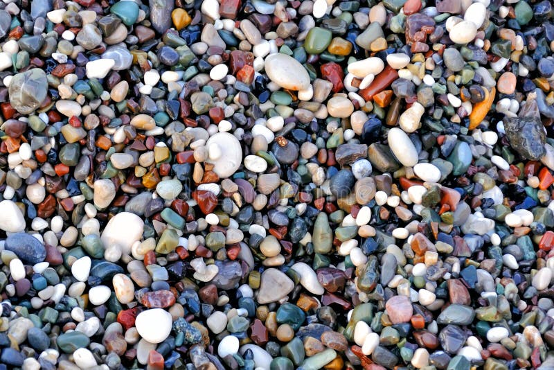 Beautiful texture of wet multicolored pebbles on the sea shore, a unique pattern for design, background, wallpaper, sea ​​shore, beach. Beautiful texture of wet multicolored pebbles on the sea shore, a unique pattern for design, background, wallpaper, sea ​​shore, beach