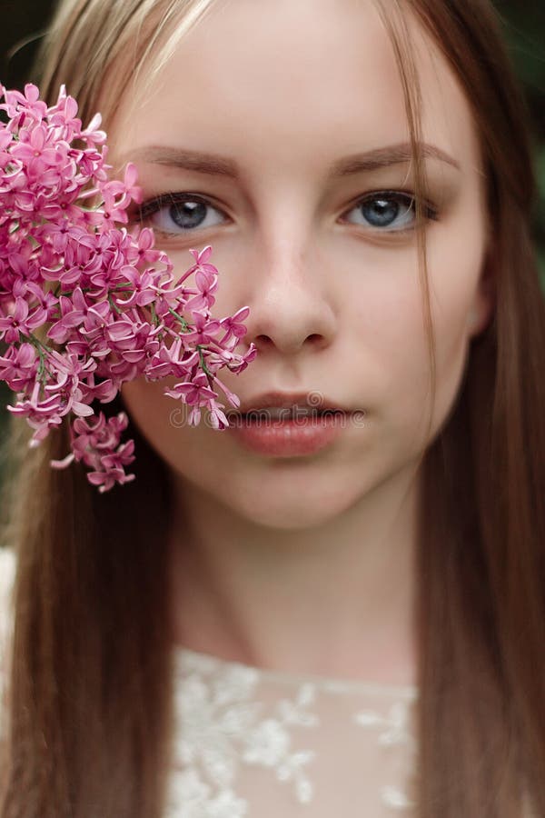Härlig ung flicka i en blomninglila fotografering för bildbyråer