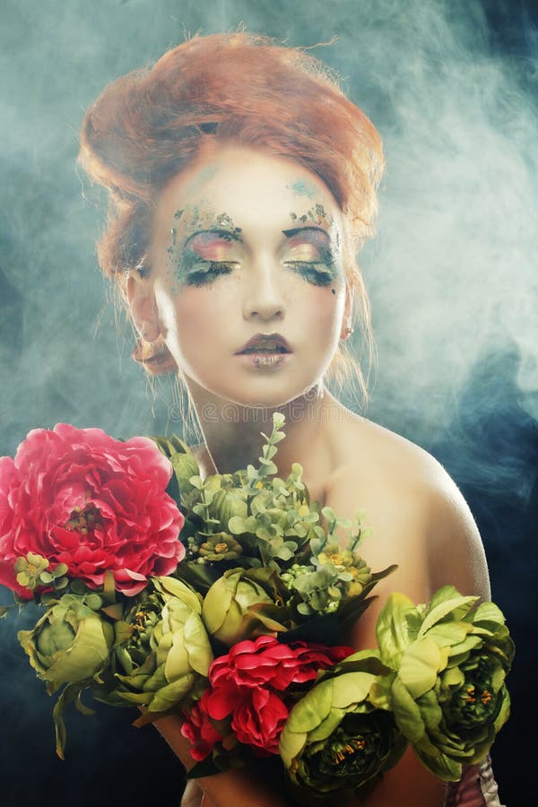 Härliga blommor för redhairkvinnainnehav royaltyfri fotografi Härliga blommor för redhairkvinnainnehav royaltyfri fotografi