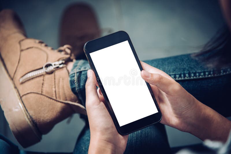 hållande mobiltelefon för hand med den tomma vita skärmen på lår med fotografering för bildbyråer hållande mobiltelefon för hand med den tomma vita skärmen på lår med fotografering för bildbyråer