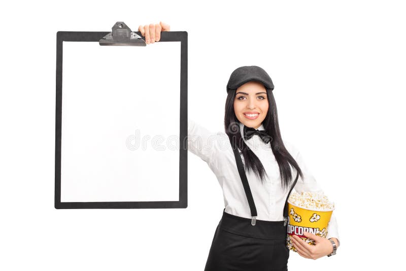 Hållande popcorn för ung kvinna och en skrivplatta royaltyfria bilder Hållande popcorn för ung kvinna och en skrivplatta royaltyfria bilder