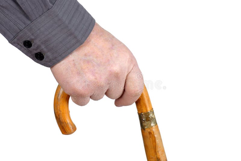 Senior man's hand hording an old wood cane to support himself as he walks, great details. Senior man's hand hording an old wood cane to support himself as he walks, great details.