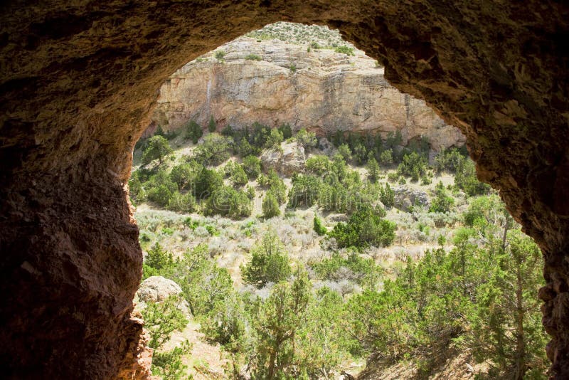 Madison Limestone formation is evident in the view from within this cave. Rocky Mountain Juniper cover the nearby area and greet the cave dwellers. Madison Limestone formation is evident in the view from within this cave. Rocky Mountain Juniper cover the nearby area and greet the cave dwellers.