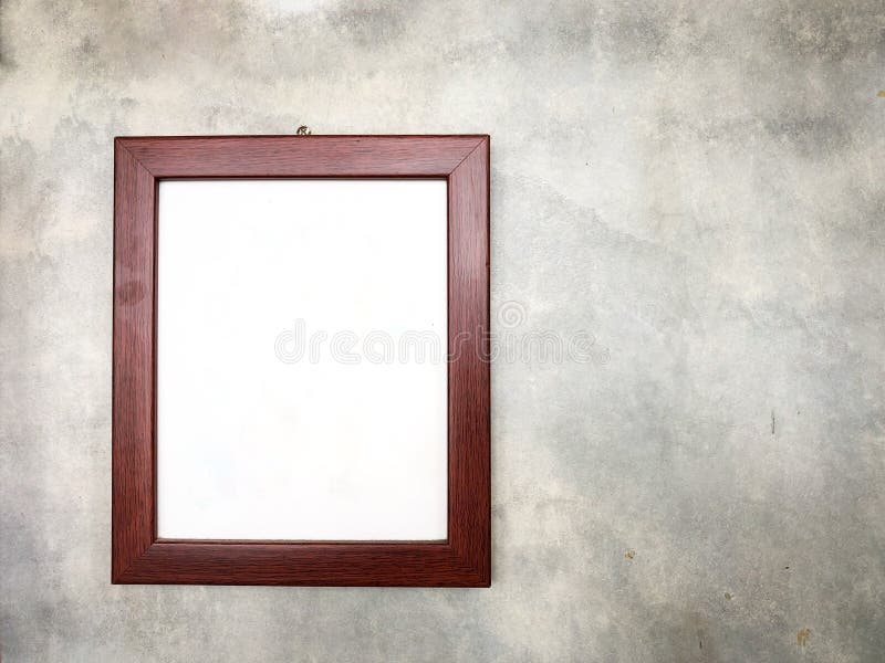 Hölzerner Bilderrahmen auf Betonmauer lizenzfreie stockfotografie Hölzerner Bilderrahmen auf Betonmauer lizenzfreie stockfotografie