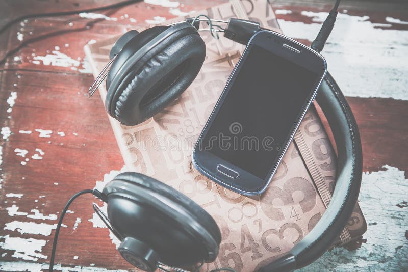 Hörlurar och telefontappningfoto, lyssnar till musik arkivbilder Hörlurar och telefontappningfoto, lyssnar till musik arkivbilder