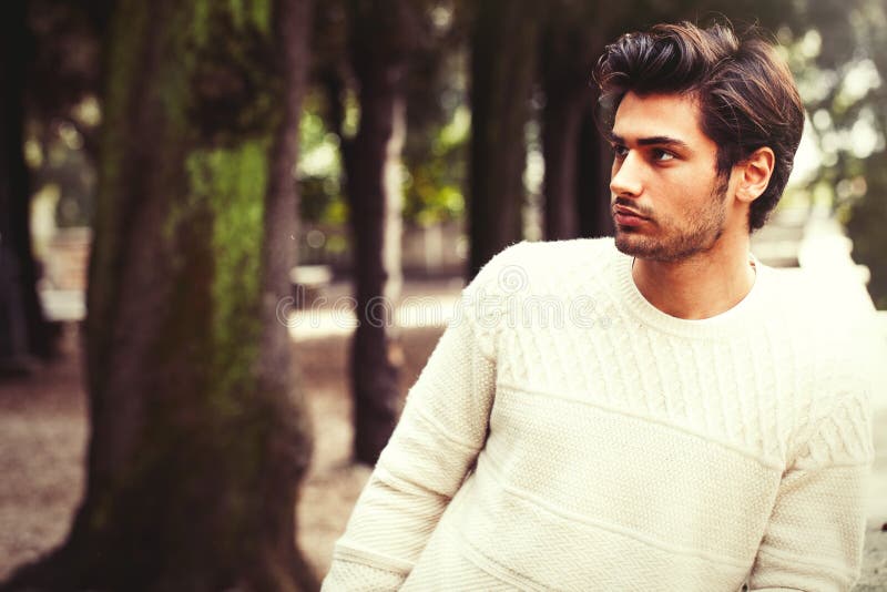 Hübsches ruhiges und nachdenkliches Modell des jungen Mannes in Bäume parken stockbilder Hübsches ruhiges und nachdenkliches Modell des jungen Mannes in Bäume parken stockbilder