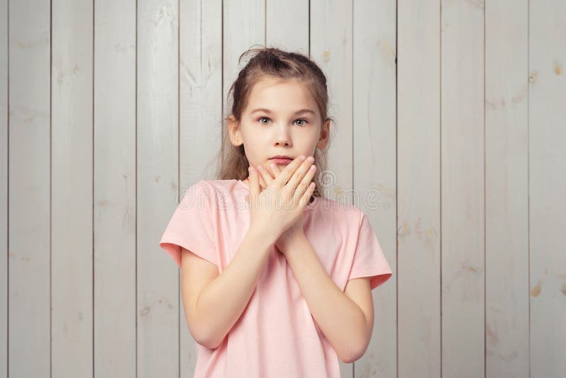 Close up of a young scared and frightened woman, covering herself