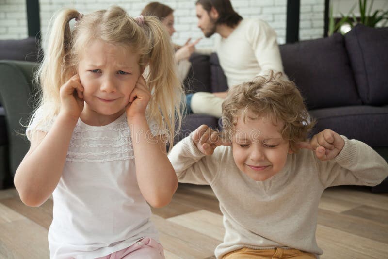 Children put fingers in ears during parents fight at home, sad stressed son daughter feel hurt suffer from psychological mental problem caused by family conflicts arguments, kids and divorce concept. Children put fingers in ears during parents fight at home, sad stressed son daughter feel hurt suffer from psychological mental problem caused by family conflicts arguments, kids and divorce concept