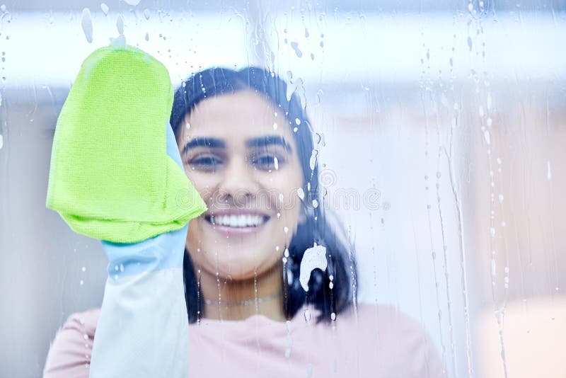 I Can See Clearly Now. a Young Woman Cleaning Windows at Home. Stock