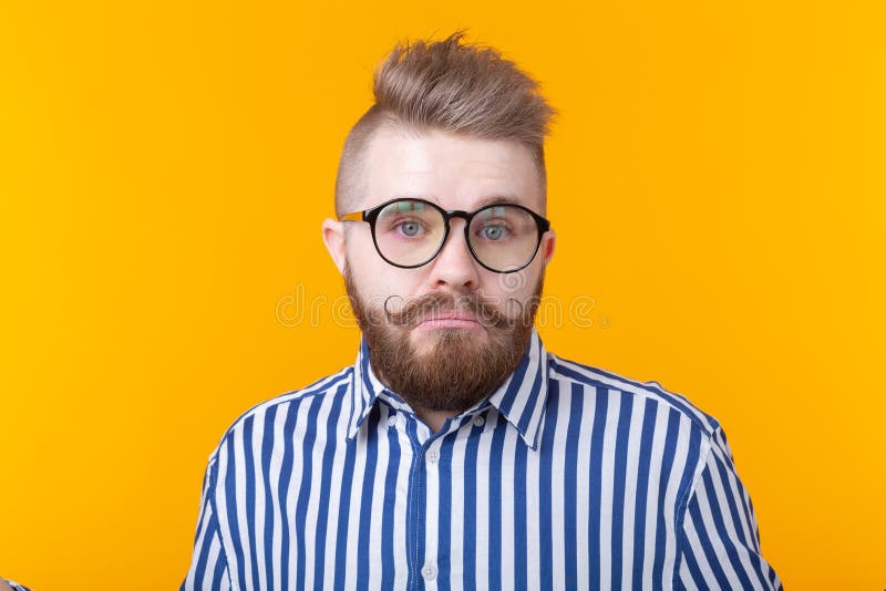 I don`t know. Young man isolated on yellow background being at a loss, showing helpless, mouth curved as if he does not royalty free stock photos I don`t know. Young man isolated on yellow background being at a loss, showing helpless, mouth curved as if he does not royalty free stock photos