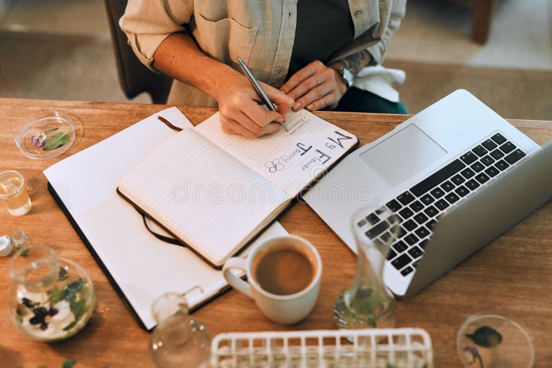 I dot down my findings every day. Cropped shot of an unrecognizable botanist doing research and writing notes in her stock images