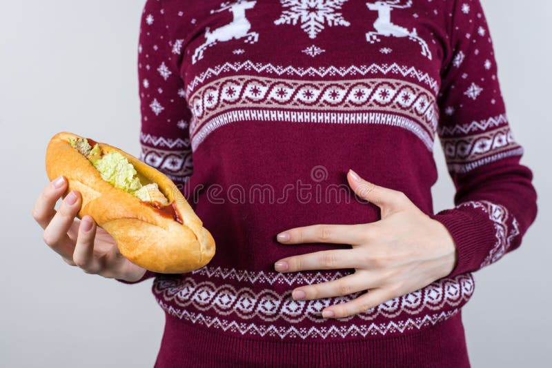 I am full concept. Cropped close up photo of girl feeling bad after eating lot of meal and junk food holding touching painful