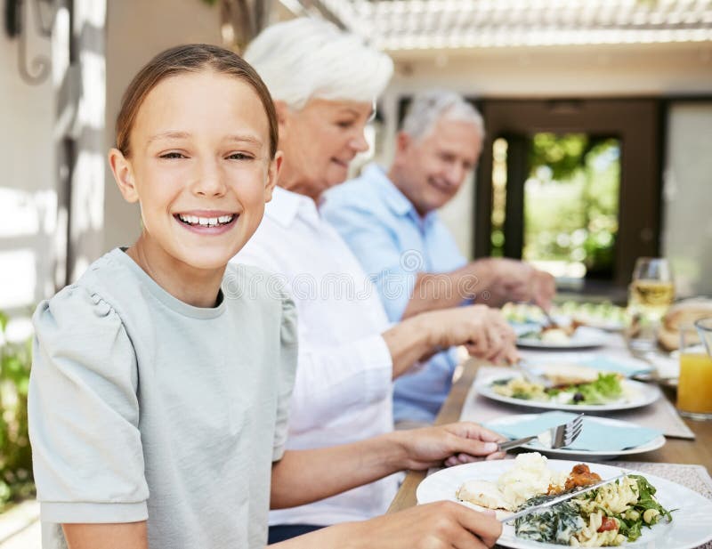 I Love Family Dinners. an Adorable Little Girl Enjoying a Meal with Her