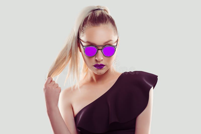 I love purple. confident successful beautiful attractive young woman fashion girl with pink sunglasses and lipstick pulling out