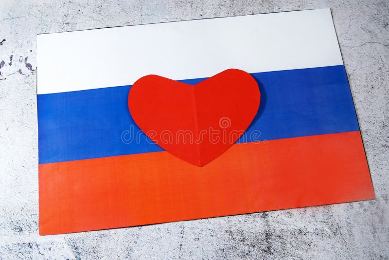 we love Russia, A group of people pose next to the Russian flag ilustração  do Stock