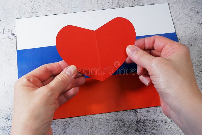 we love Russia, A group of people pose next to the Russian flag ilustração  do Stock