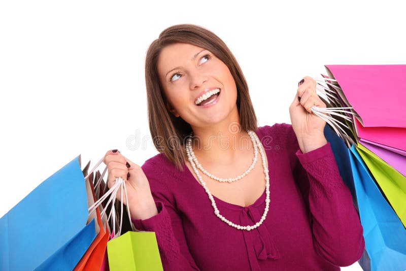 A picture of a young happy woman with shopping bags over white background. A picture of a young happy woman with shopping bags over white background