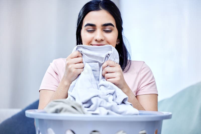 I Love the Smell of Freshly Washed Clothes. a Young Woman Doing Laundry ...