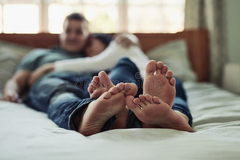 I Love It When Your Feet Touches Mine A Couples Feet As They Lay On Bed Stock Image Image Of