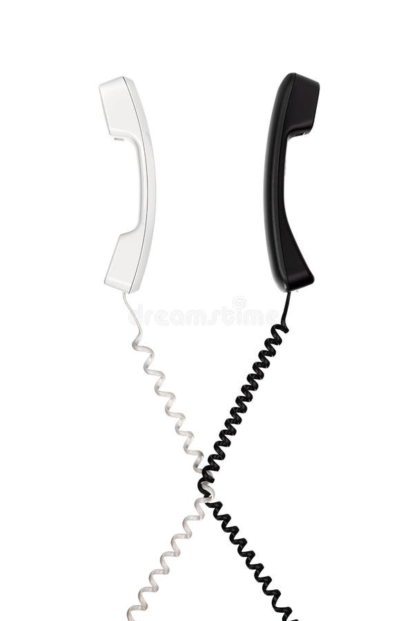 I microtelefoni con i cavi attraversati guardano nelle direzioni differenti fotografia stock I microtelefoni con i cavi attraversati guardano nelle direzioni differenti fotografia stock