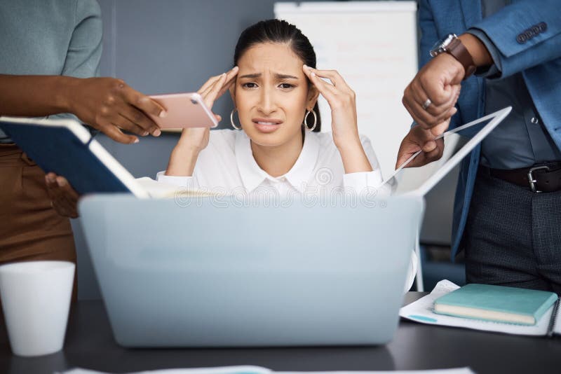 I need more hands to get everything done on time. a young businesswoman looking stressed out in a demanding office royalty free stock photos