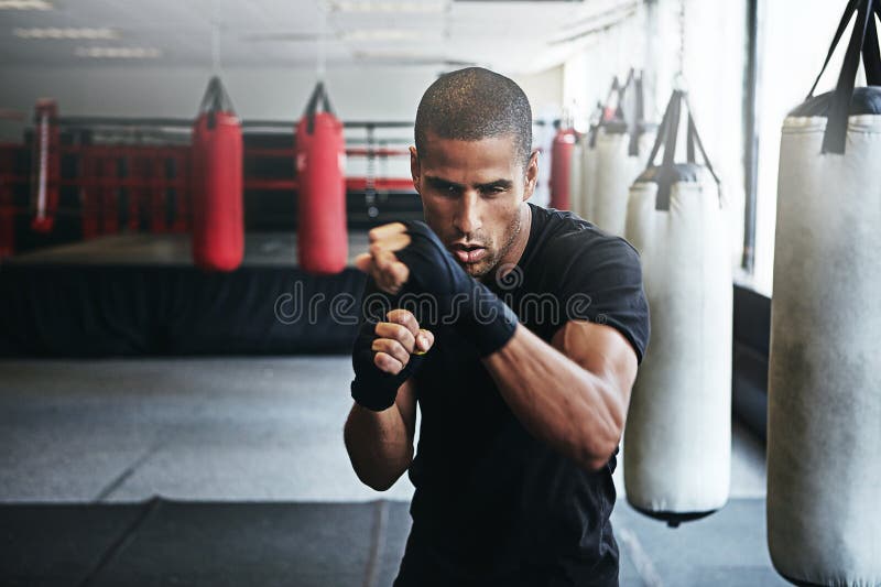 I Want To Be the Best. a Kickboxer Training in a Gym. Stock Photo