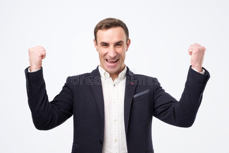 Pleased and happy young italian man is smiling broadly and showi stock image Pleased and happy young italian man is smiling broadly and showi stock image