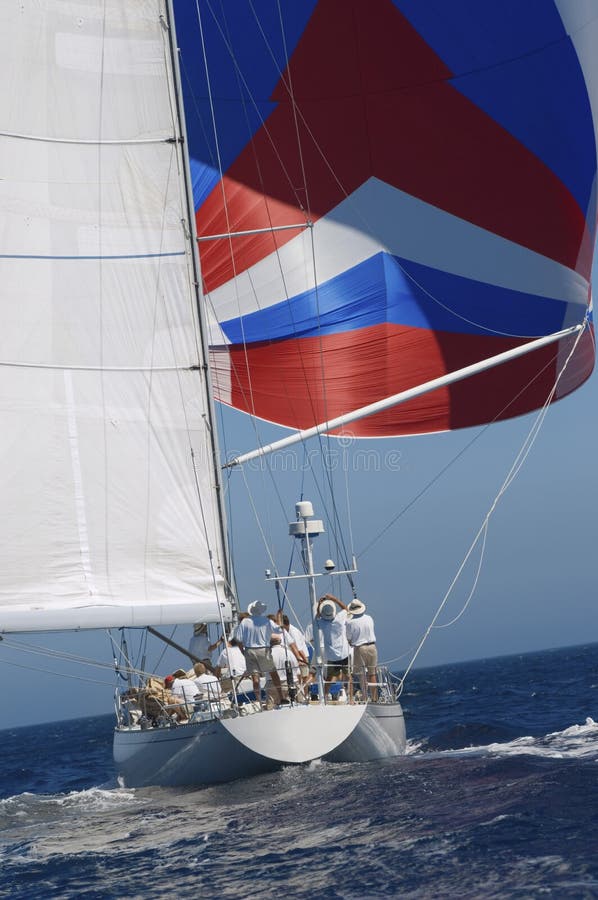 Rear shot of a yacht at full sail in the ocean against the clear sky. Rear shot of a yacht at full sail in the ocean against the clear sky