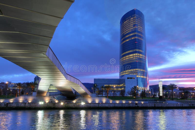 The latest addition to Bilbao (Spain) skyline is the 165m Iberdrola Tower recently inaugurated. Build next to the Guggenheim Museum in a former industrial area, the curent composition surprises only the tower at twilight time as seen from under the Pedro Arrupe Bridge from the opposite side of Nervion river. The latest addition to Bilbao (Spain) skyline is the 165m Iberdrola Tower recently inaugurated. Build next to the Guggenheim Museum in a former industrial area, the curent composition surprises only the tower at twilight time as seen from under the Pedro Arrupe Bridge from the opposite side of Nervion river.