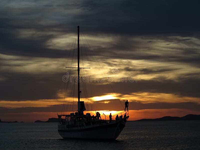 Silhouette of a Party Boat cruising in front of the sunset in Ibiza Spain, as taken from the Cafe Del Mar. Silhouette of a Party Boat cruising in front of the sunset in Ibiza Spain, as taken from the Cafe Del Mar.