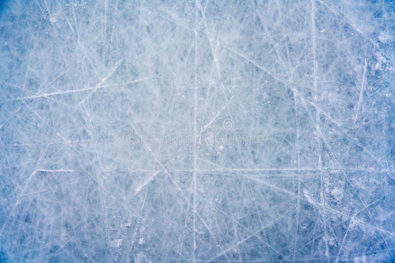 Ice background with marks from skating and hockey, blue texture of rink surface with scratches