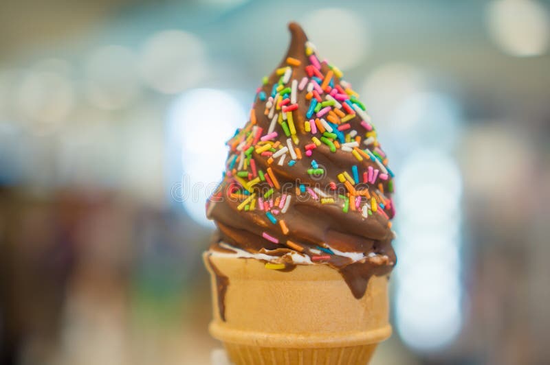 Download Ice Cream Cone With Chocolate And Rainbow Color Sprinkles On Blu Stock Image - Image of classic ...