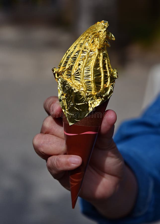 Ice cream cone covered in edible gold leaf.