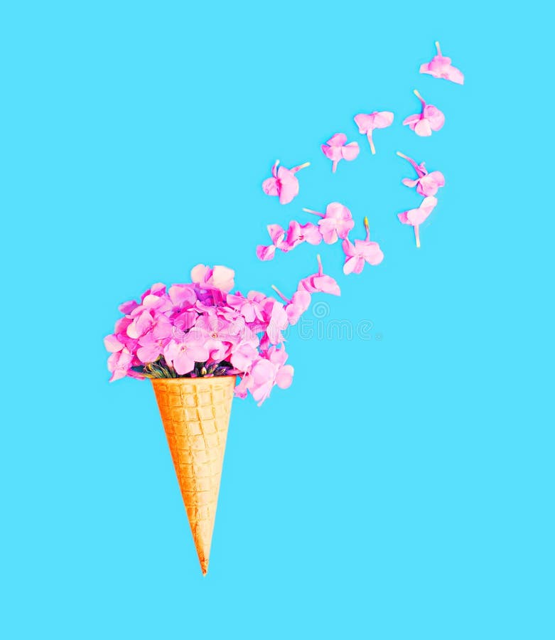Ice Cream Cone with Petals Flowers Over Blue Background Stock Photo
