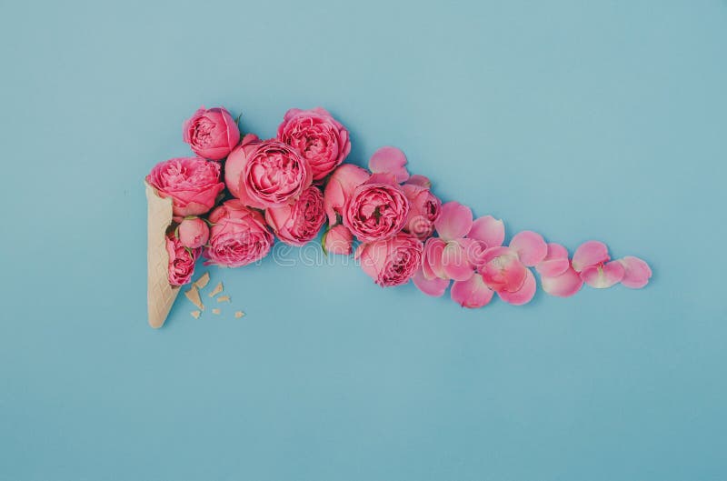 Ice cream cone with pink roses on a blue background. Flat lay, top view. Wedding cone stock images, royalty-free photos and pictures