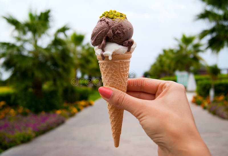 Ice cream cone in woman hand royalty free stock photo