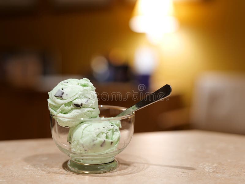 Ice cream in glass dish with spoon. Delicious mint chocolate chip