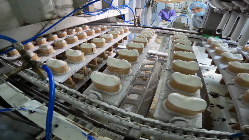 Ice cream after freezing at the factory. Ice cream production process. Making ice cream in a cup at the factory. stock video