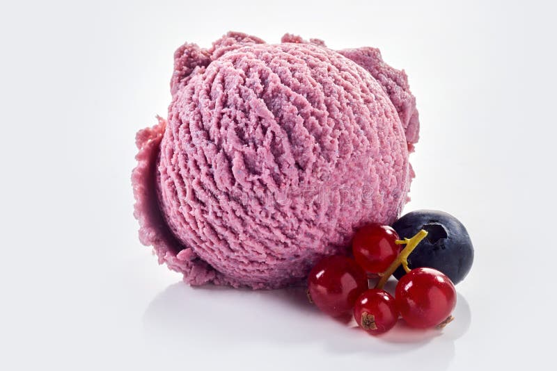 Ice cream scoop with redcurrant and blueberry