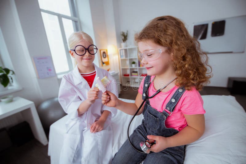 Funny girls eating ice cream after visiting pediatrician together royalty free stock photos Funny girls eating ice cream after visiting pediatrician together royalty free stock photos