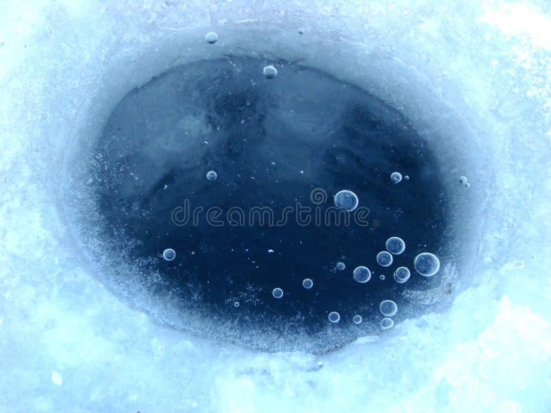 Ice-hole in ice on a pond