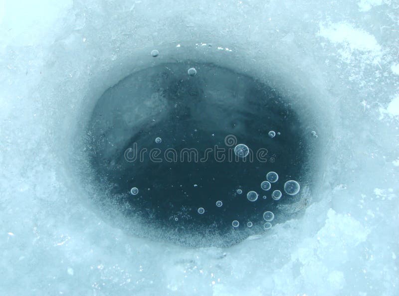 Ice-hole in ice on a pond