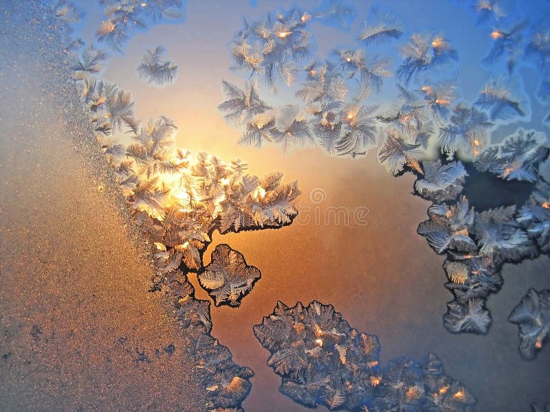 Ice pattern and sunlight on winter glass