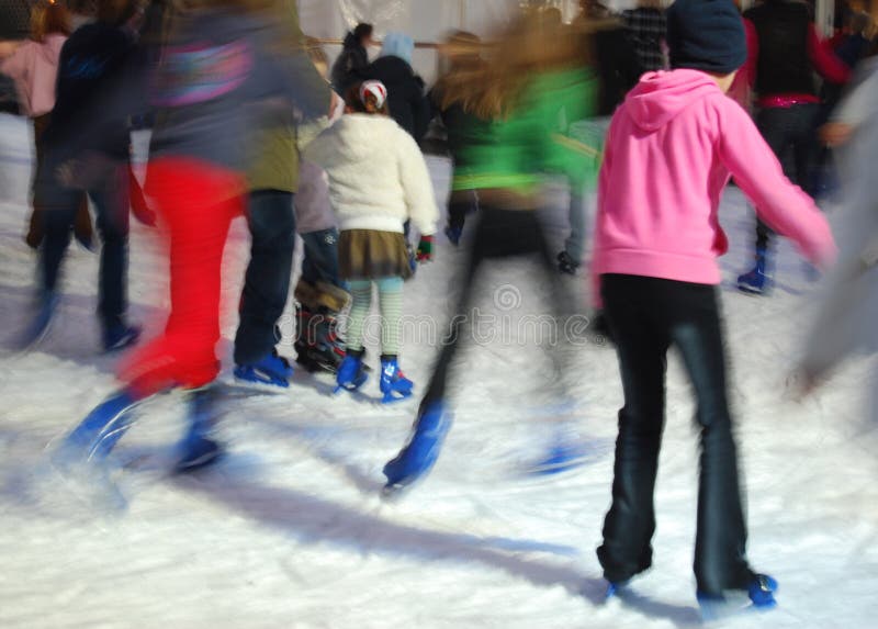 Skaters having fun in ice ring. Taken with slow shutter speed. Skaters having fun in ice ring. Taken with slow shutter speed.