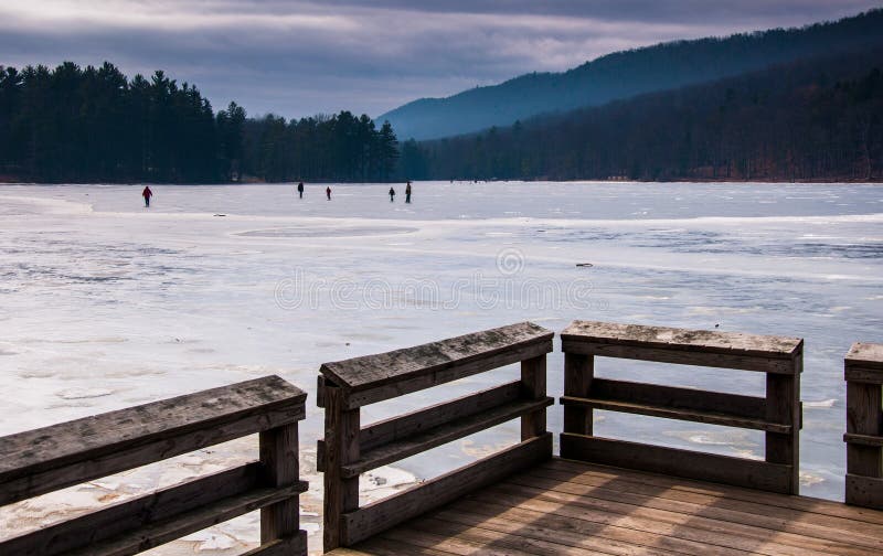 Ice skaters on a frozen lake at Cowans Gap State Park, Pennsylvania.