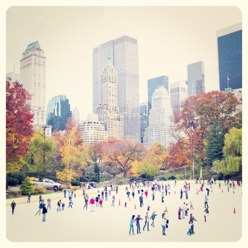 Ice skaters having fun in New York Central Park in fall with Instagram effect filter
