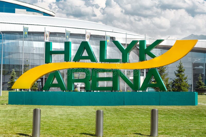 Ice sport arena Almaty city - Halyk Arena. Close-up logo on green grass