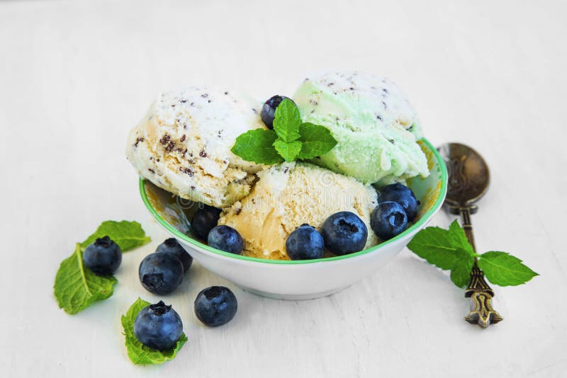 Icecream cups with blueberries and mint stock images
